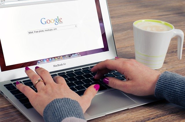 A woman using her laptop to search on Google