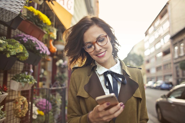 A woman shops using her mobile phone